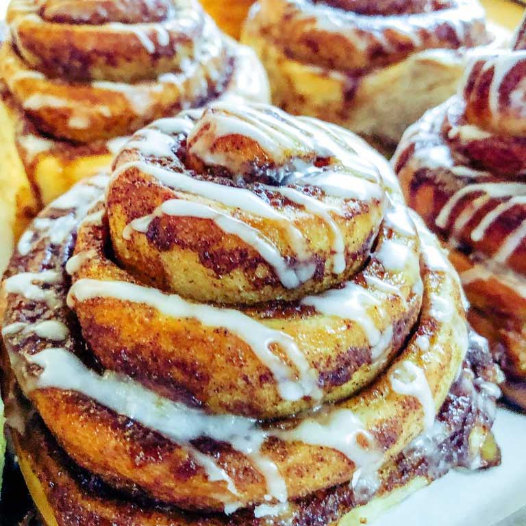 A tray of Spring Hill Bakery cinnamon rolls with cream cheese frosting